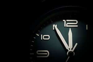 Be More Productive - Dial of a clock showing five minutes to twelve